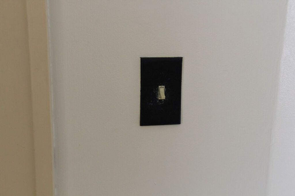 A Light Switch Beside The Door